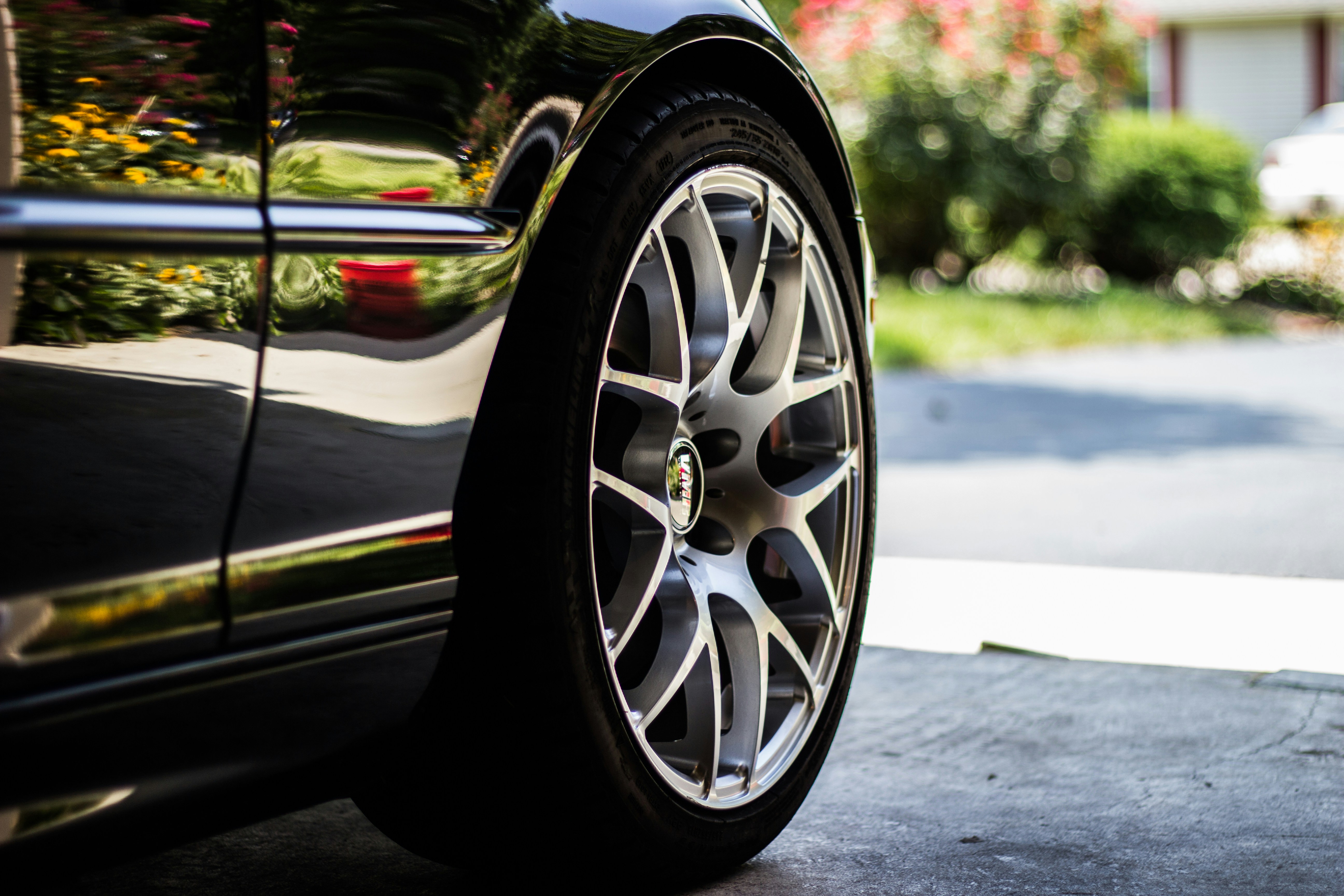 Close-up of a car's alloy wheel in a driveway