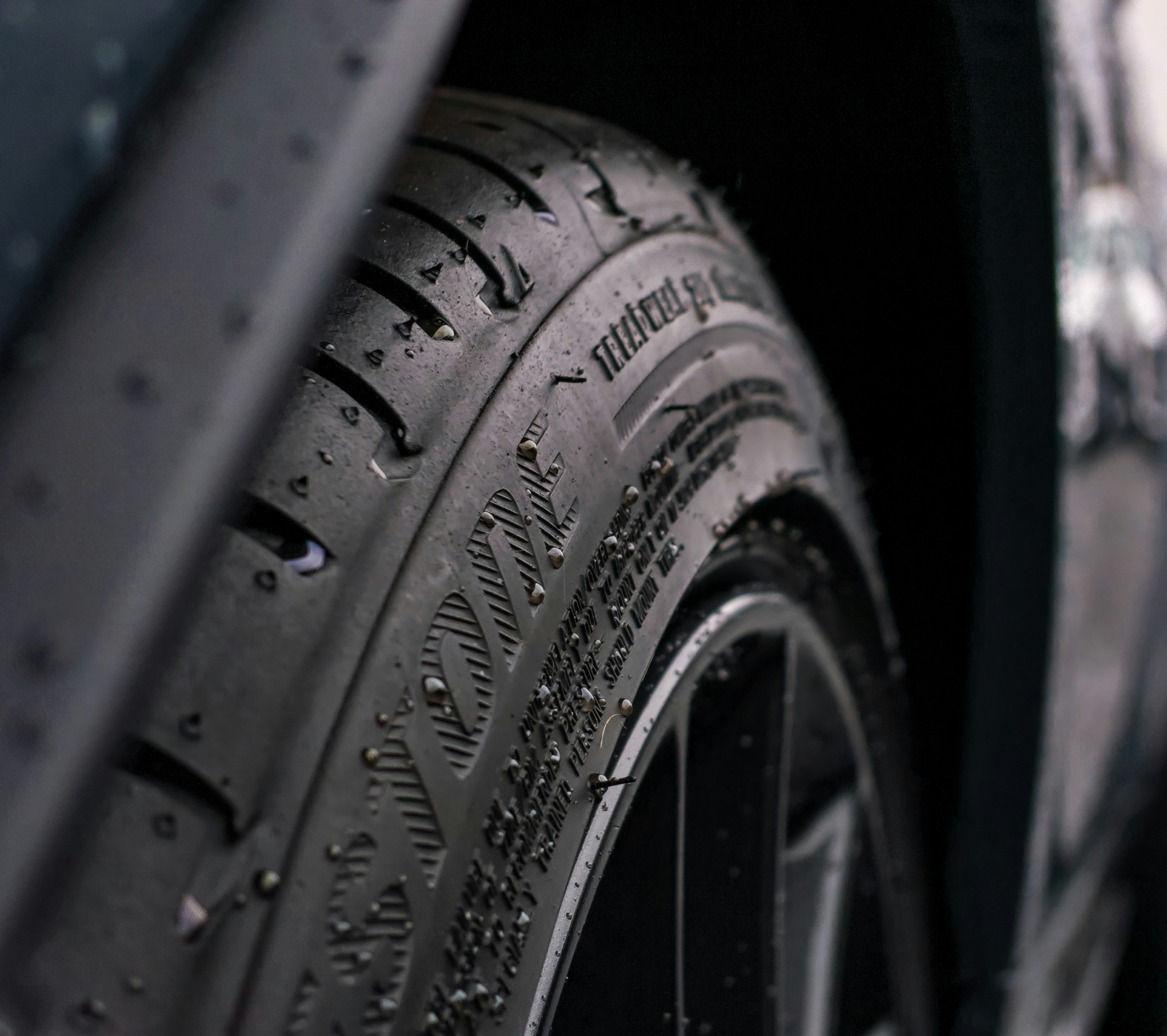 Close-up of a wet tire tread and wheel